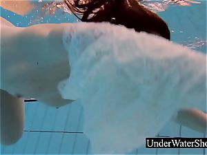 luxurious ginger-haired in the white sundress underwater